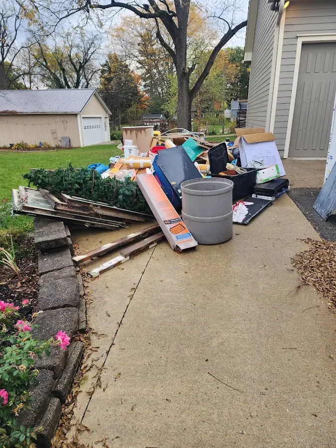 Dumpster being loaded with debris for Estate Cleanout Dumpster Rental in Red Lion